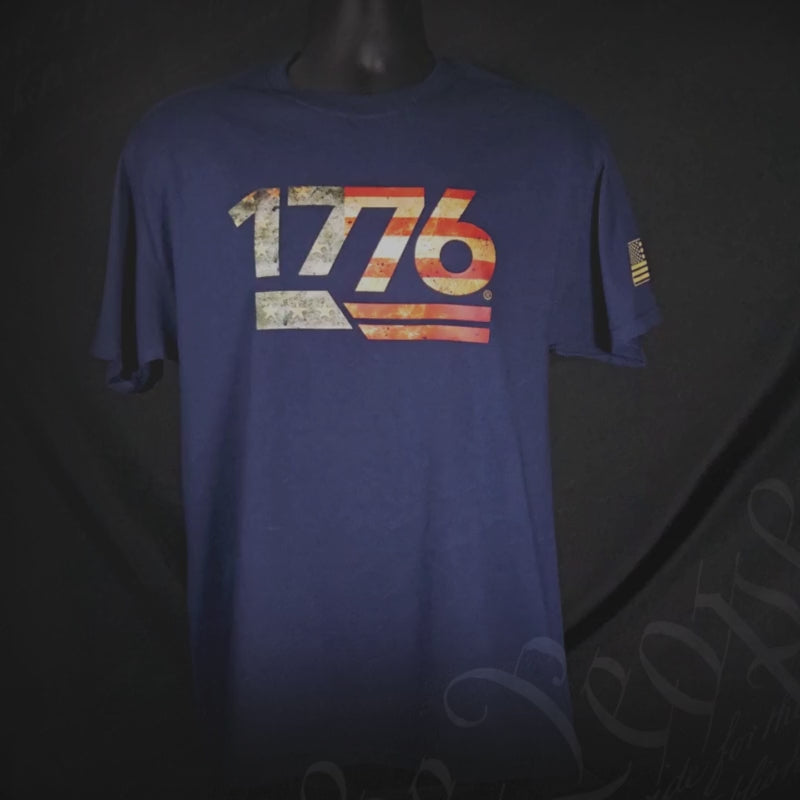 Legacy '76 Men's Tee in navy blue featuring a vintage 1776 design and American flag detail for patriotic style.